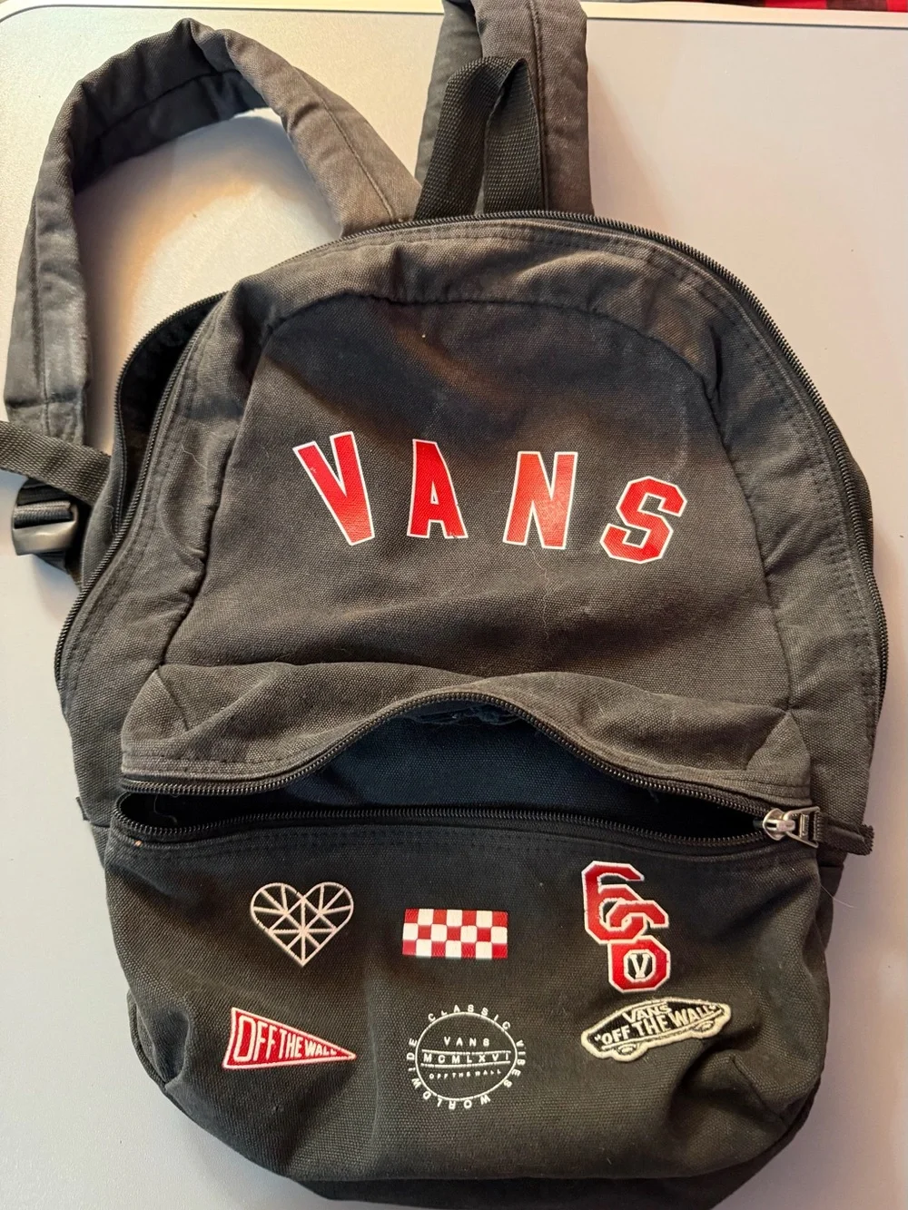 Vans Black Canvas Backpack with Red Lettering and Patch Accents